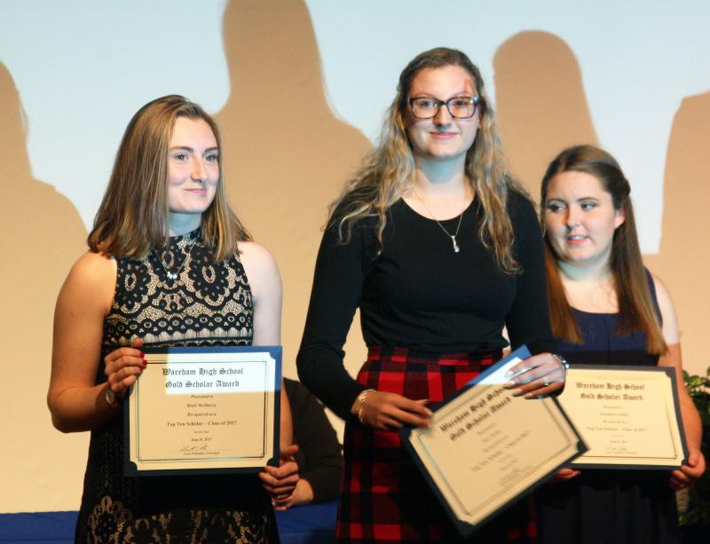 Class of 2017 Valedictorian Brett McSherry, left, and Salutatorian Sara Tyma, center, stand on stage with other Gold Scholar Award winners on Thursday. BY MATTHEW BERNAT